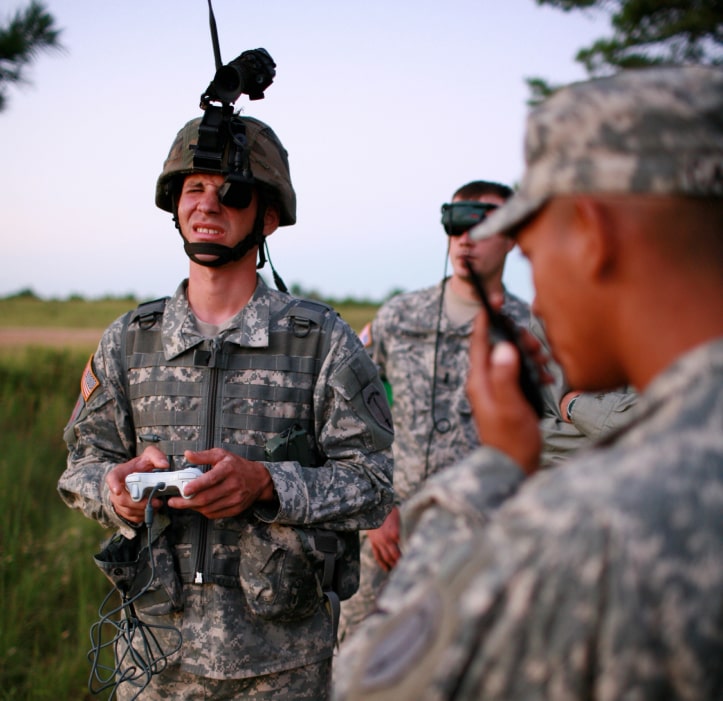 young soldier using AR goggles and an X-box controller